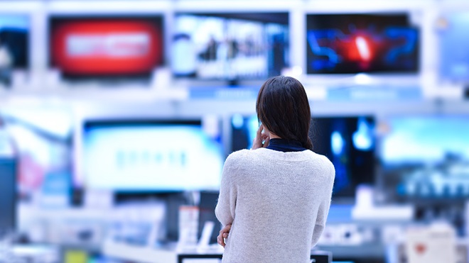woman choosing a TV in store